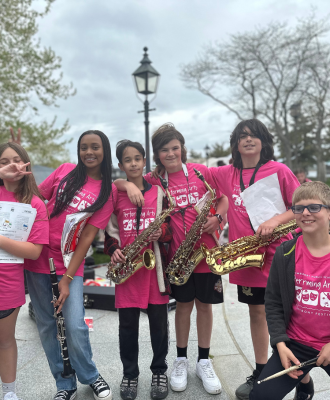 Middle school students posing with instruments